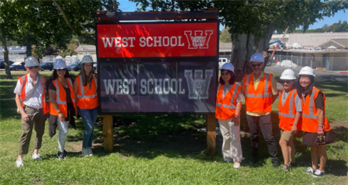 Construction team in front of West Marquee